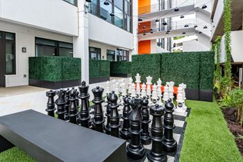 a giant chess board in the middle of a garden
